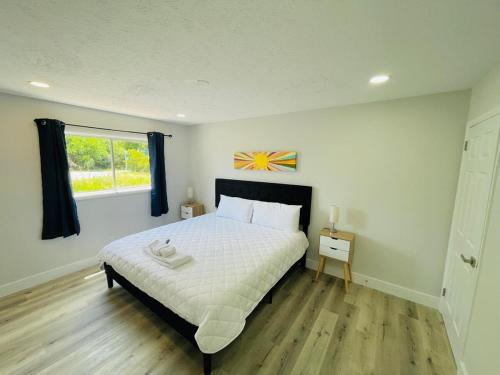 a bedroom with a large bed and a window at Perfect Vacation walk to the beach 9 in Myrtle Beach
