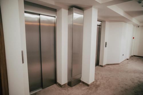 a row of elevator doors in a building at Hotel Bavka in Leskovac