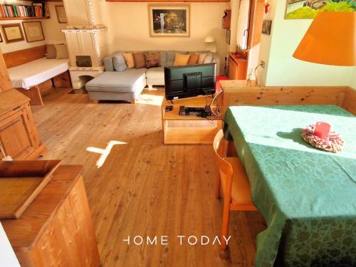 a living room with a table and a couch at HT - Ciasa Dahu Cortina Escape in San Vito di Cadore