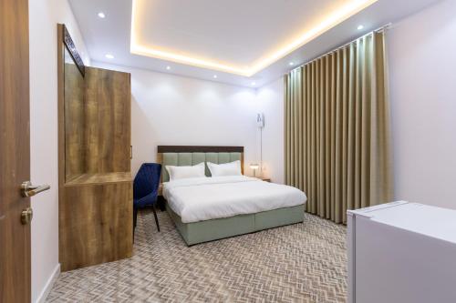 a hotel room with a bed and a door at Al-Jamwaut B in Medina