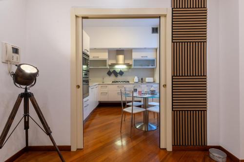 a kitchen with a table and a dining room at Monica's Nest - A due passi dal Centro Storico in Monza