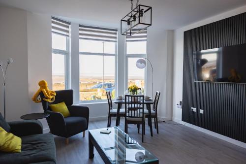 a living room with a table and chairs at Sunbeam House 2 Morecambe Accessible in Morecambe