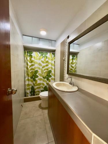 a bathroom with a sink and a toilet and a mirror at Beach house Sol Mar y Relax in Cerro Azul