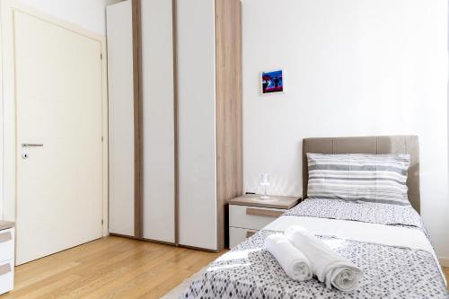a bedroom with a bed with towels on it at Ca'Rosa Venezia in Venice