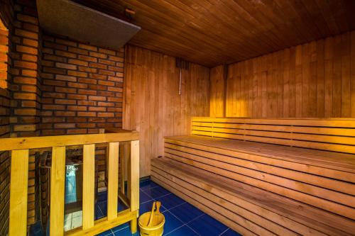 a sauna with wooden benches and a brick wall at Zotavovna VS Přední Labská in Přední Krausovy Boudy