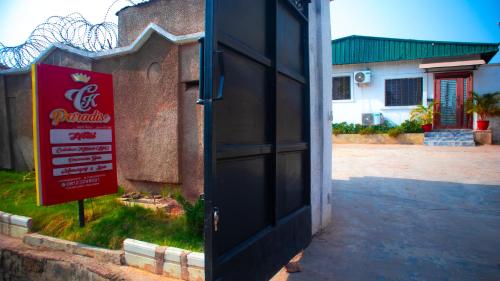 a door to a building with a sign next to it at CK paradise hotel in Ibadan