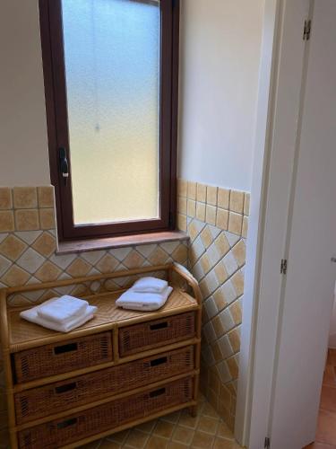 a bathroom with a window and two towels at Spacious Apartment in Montallegro with Stunning Views in Montallegro