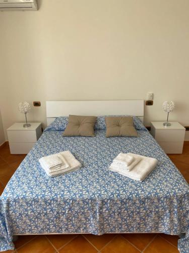 a bedroom with a bed with two towels on it at Spacious Apartment in Montallegro with Stunning Views in Montallegro