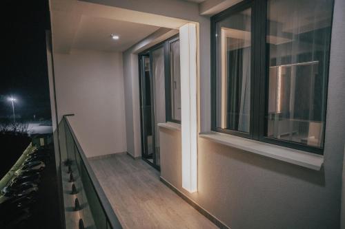 a balcony of a house with two windows at Hotel Bavka in Leskovac