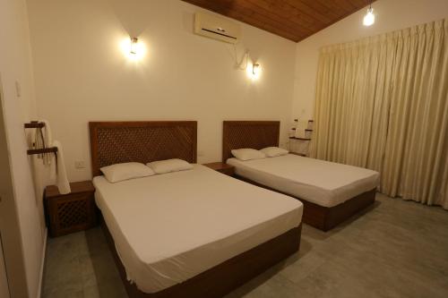 Postel nebo postele na pokoji v ubytování Serenity Villa Anuradhapura