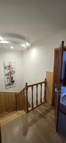 a room with a staircase with a wooden railing at Tract House in Lviv