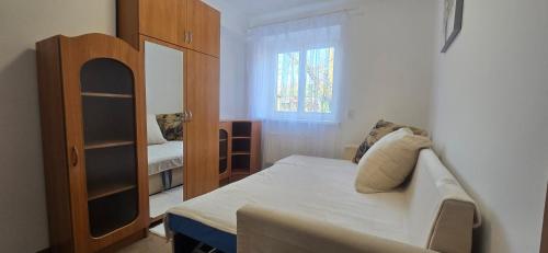 a small bedroom with a bed and a window at Tract House in Lviv