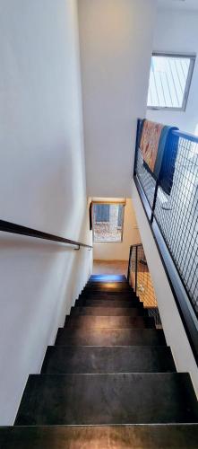 a staircase in a building with two windows and a stair case at Elegant Townhome in Heart of Down Town in Albuquerque