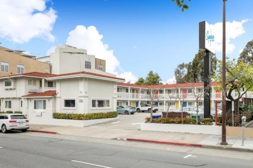 a street view of a building with a parking lot at Signature Inn Berkeley in Berkeley