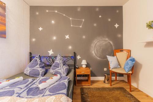 a bedroom with two beds and a chair at - Stellar Haven Deluxe with Cosmic Design - 3-Room Space-Themed Apartment 75 qm - Central Location - Balcony - Renovated 2024 with TV & Netflix - Full Kitchen - Free Parking - Near Metro & Airport - Galaxy-Inspired Interior - in Duisburg