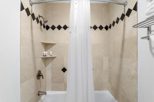 a bathroom with a shower with a shower curtain at Signature Inn Berkeley in Berkeley