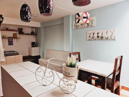 a kitchen and dining room with two tables and chairs at Hotel Jardines del Carmen in San Cristóbal de Las Casas