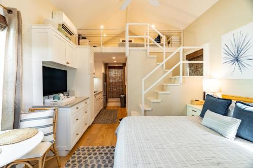 a room with a bed and a staircase at Key West Light Suite in Key West