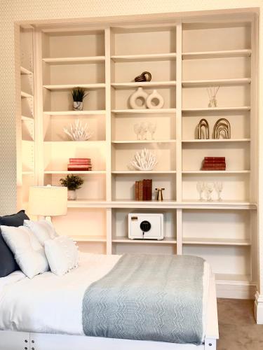 a bedroom with white shelves and a bed at The Underwood-Hale House in Providence