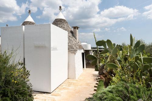 a white building with two towers on top of it at Cocotrullo in Cisternino
