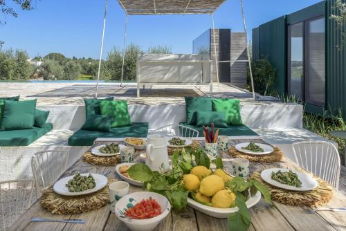 a table with plates of food on a patio at Cocotrullo in Cisternino