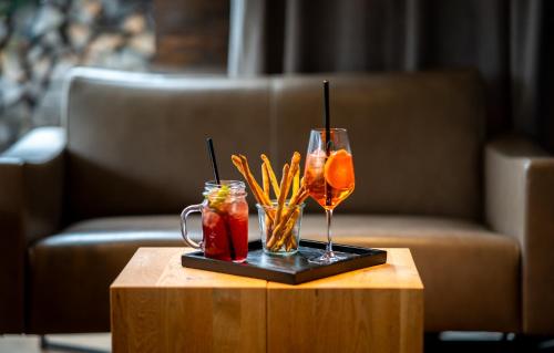 a table with a drink and a glass on a table at Hotel Artist in Biel