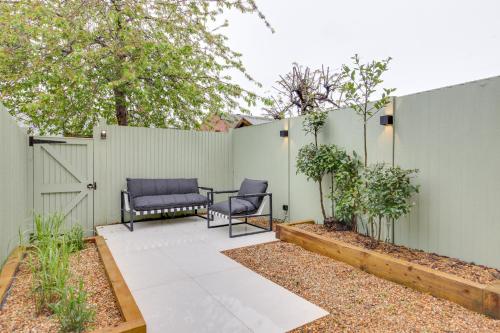 a patio with two chairs and a fence at Luxury Two Bedroom Cottage - Bishops Stortford in Bishops Stortford