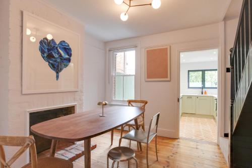 a dining room with a table and chairs and a fireplace at Luxury Two Bedroom Cottage - Bishops Stortford in Bishops Stortford