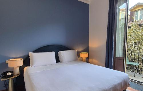 a bedroom with a white bed and a window at Antica Locanda Leonardo in Milan