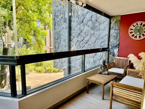 a room with a large window with benches and a clock at Lago y Volcán in Pucón