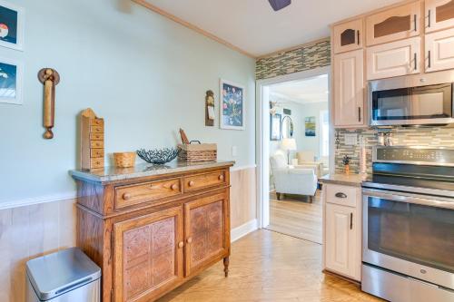 a kitchen with wooden cabinets and a stove top oven at Radford Home with Wraparound Deck! in Radford