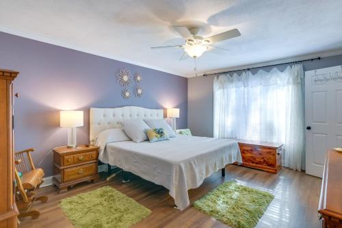 a bedroom with a white bed and a ceiling fan at Radford Home with Wraparound Deck! in Radford