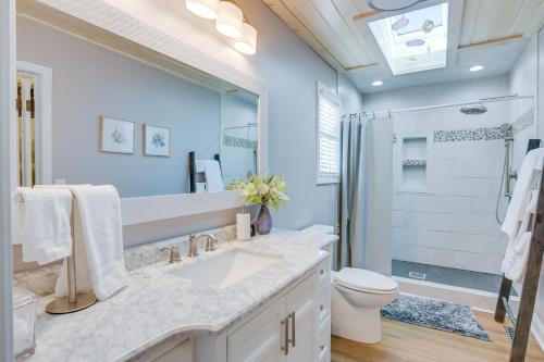 a bathroom with a sink and a toilet and a shower at Radford Home with Wraparound Deck! in Radford