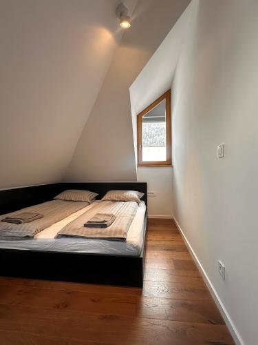 a bedroom with a bed and a window at Nordic Sun 01 in Kranjska Gora