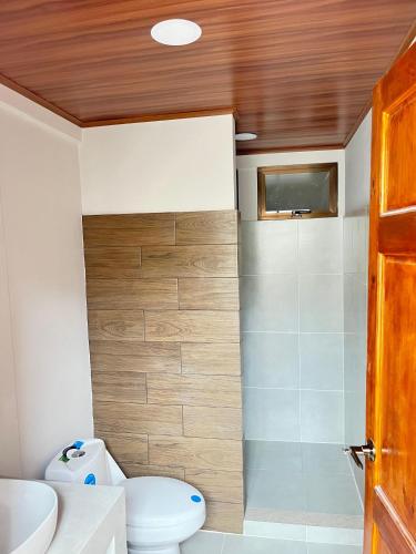 a bathroom with a toilet and a sink and a shower at Bajamar, Puntarenas in Puntarenas