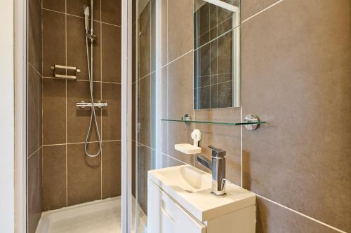 une salle de bain avec une douche et un lavabo et une douche dans l'établissement Louvre Museum 35 mins away, à Saint-Maurice