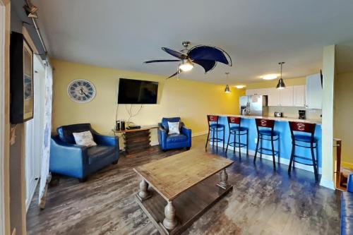 a living room with a table and chairs and a kitchen at Put-in-Bay Waterfront Condo #111 in Put-in-Bay