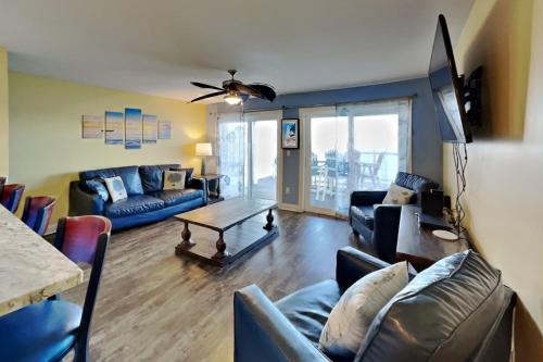 a living room with a couch and a table at Put-in-Bay Waterfront Condo #111 in Put-in-Bay