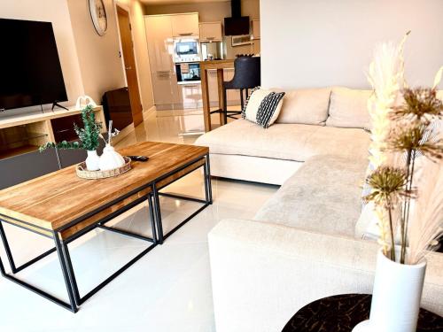 a living room with a couch and a table at Luxe Cardiff Centre Apartment Free Parking in Cardiff