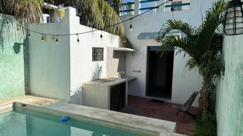 a house with a swimming pool next to a building at Casa Esperanza in Campeche