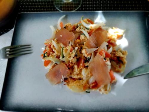 a plate of food with meat and vegetables on a table at Studio confortable à Bouillante, 56 m², vue mer, jardin clos. in Bouillante