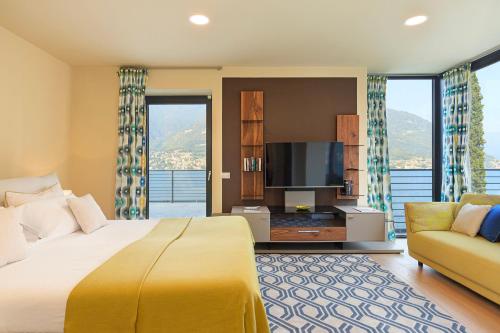 a bedroom with a large bed and a flat screen tv at Villa Felicity by My Villa Collection in Riva