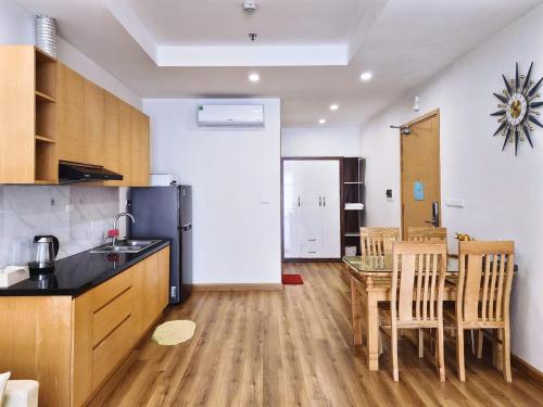 a kitchen with a table and a dining room at Seafront Apartment TMS Quy Nhơn in Quy Nhon