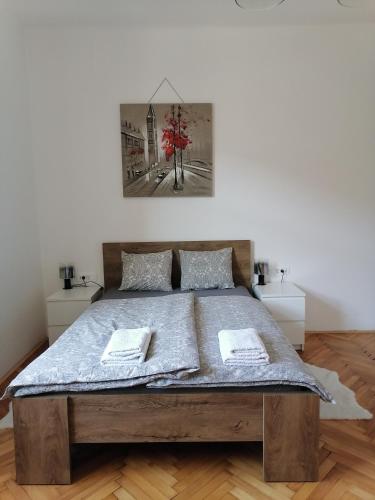 a bedroom with a large bed in a room at Pirc apartment on Dunajska street in Ljubljana
