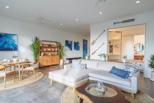 a living room with a couch and a table at Pavones - Tropical Oceanfront 1 Bedroom Apartment by Triang Villas in Tanah Lot