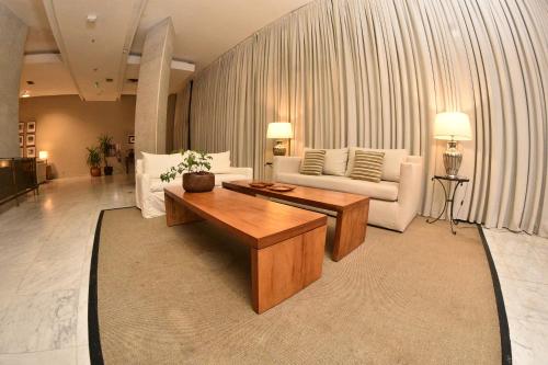 a living room with a couch and a coffee table at Hotel Guarani Asuncion in Asuncion