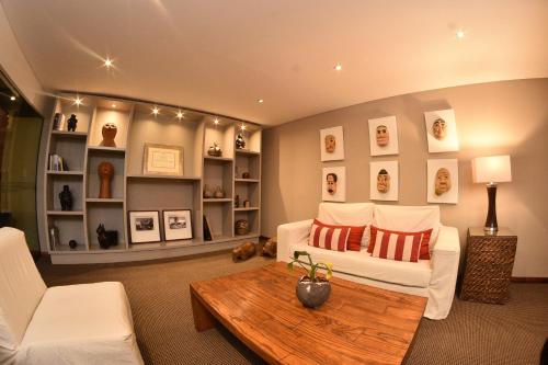 a living room with a couch and a coffee table at Hotel Guarani Asuncion in Asuncion
