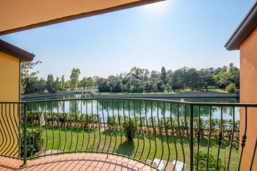 a balcony with a view of a lake at Isola di Albarella in Isola Albarella