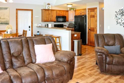 a living room with a couch and two chairs at BOHO Bungalow on the Pond w/ Hot Tub in Arnolds Park