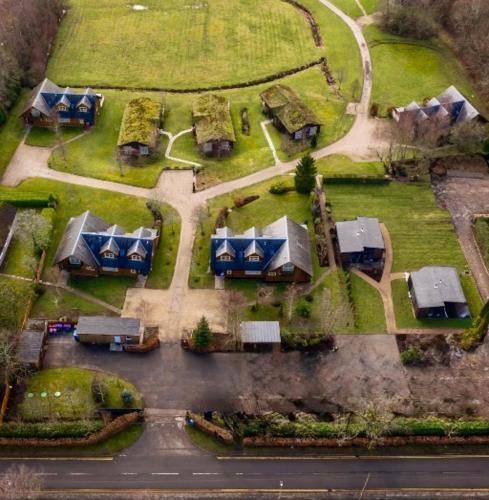 an aerial view of a bunch of houses with roofs at Loch Lomond Waterfront Luxury Lodges in Balmaha